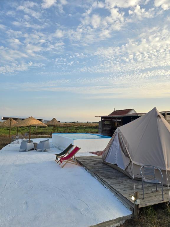a tent and chairs sitting on a wooden deck at COMPORTA SIDE - Tents in Setúbal