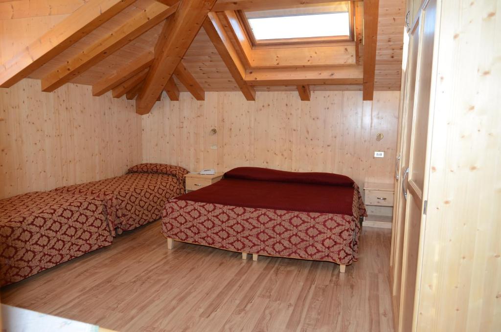Postel nebo postele na pokoji v ubytování Hotel Corona