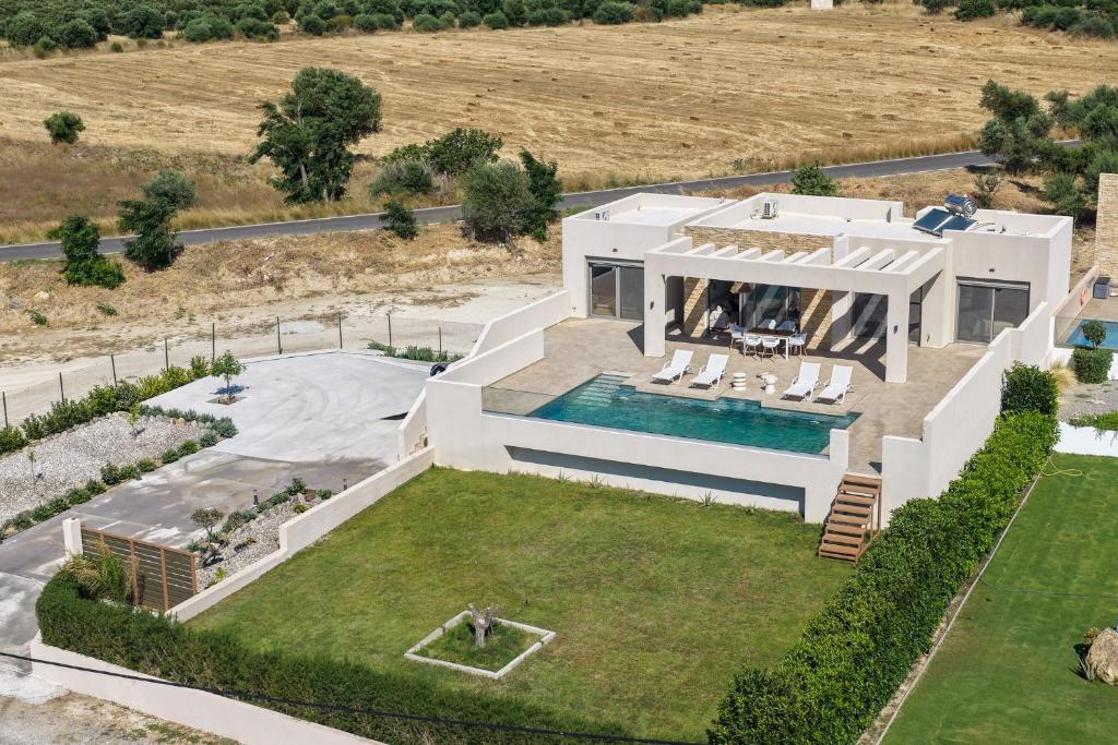 an aerial view of a house with a swimming pool at Villa Dioni in Kardamaina