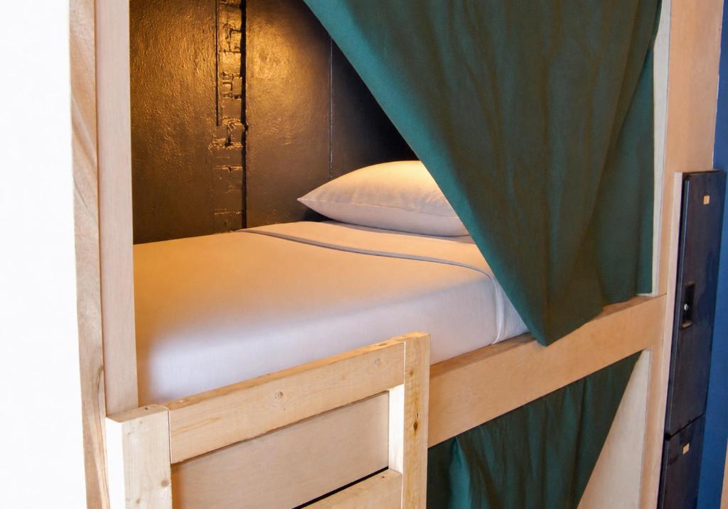 a small bunk bed in a room with a canopy at Hostel du Nord in Duluth