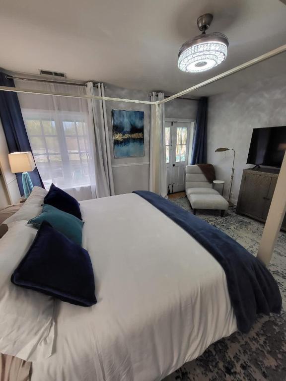 a bedroom with a large white bed with blue pillows at Terrace On Main Street in Murphys
