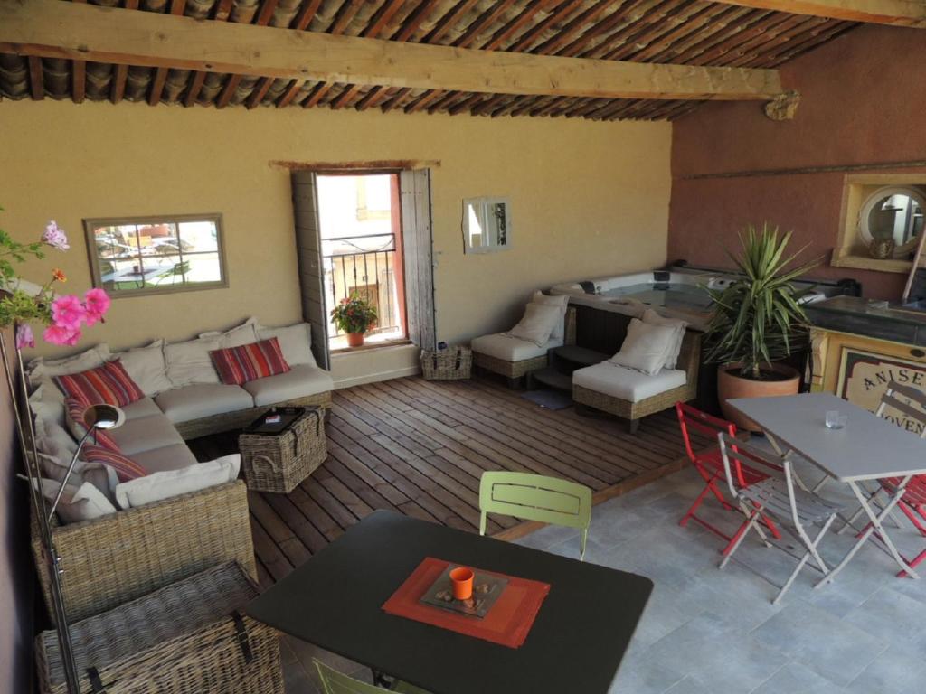 a living room with a couch and a table at Eden Roque in La Roque-dʼAnthéron