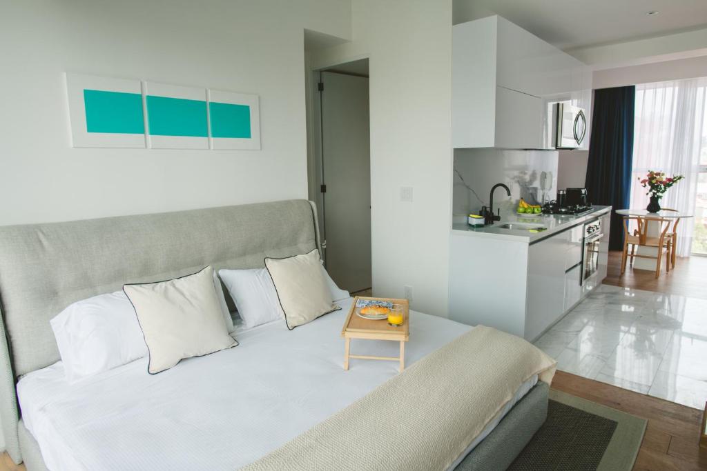 a living room with a bed and a kitchen at Icon 701- Stylish Loft W AC Premium Location in Mexico City