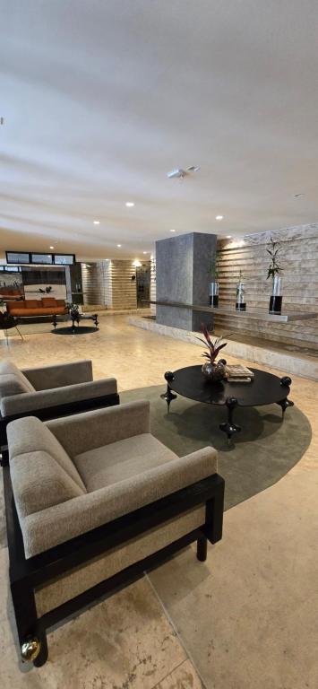 a living room with a couch and a coffee table at Opus Gyro Vaca Brava Designer in Goiânia