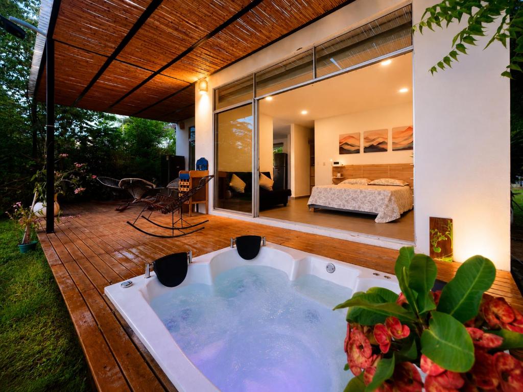 a jacuzzi tub in a backyard with a bedroom at Finca Samana in Tocaima