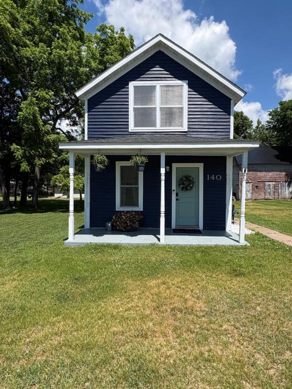 a blue house with a blue door on a yard at The Perfect Match River Retreat in Buffalo City