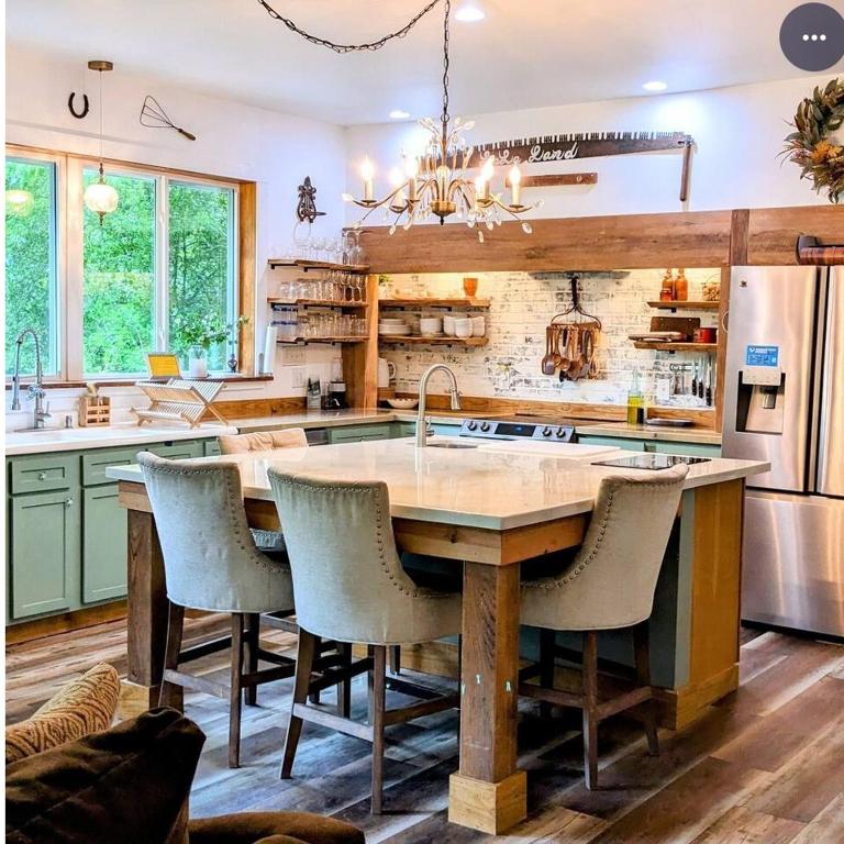 a kitchen with a large island with chairs around it at Private Beach, secluded! in Covington