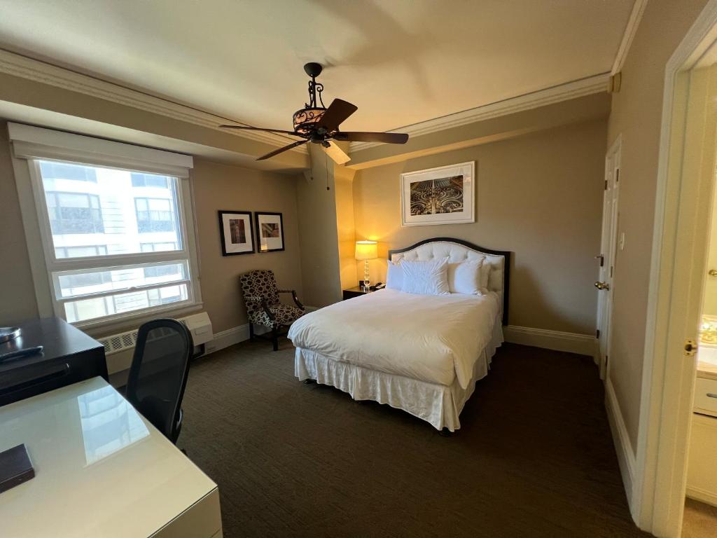 a bedroom with a bed and a ceiling fan at Kensington Park Hotel in San Francisco