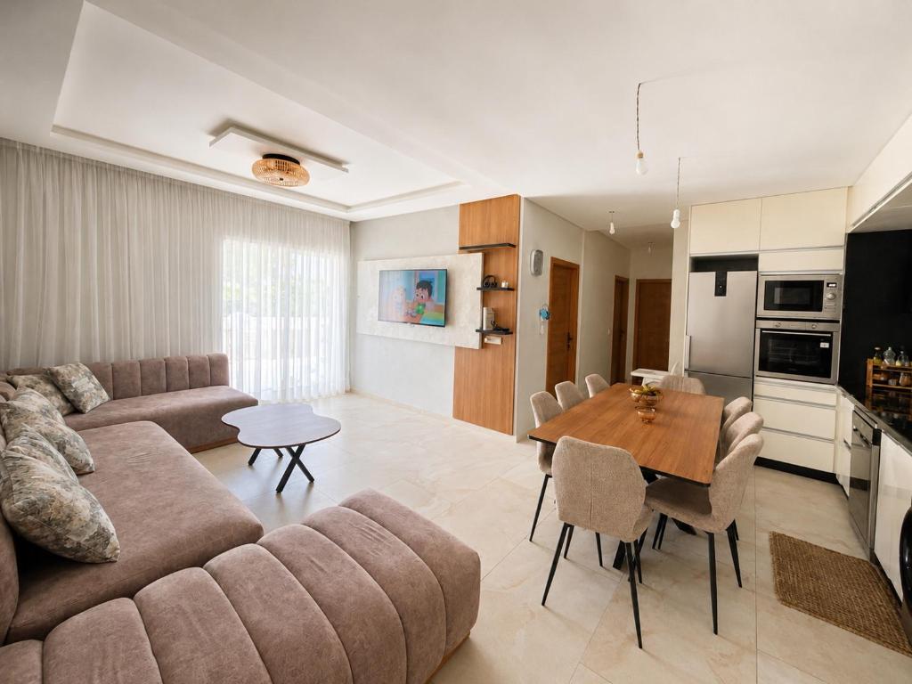 a living room with a couch and a table at Nour House Imi Ouaddar in Agadir nʼ Aït Sa