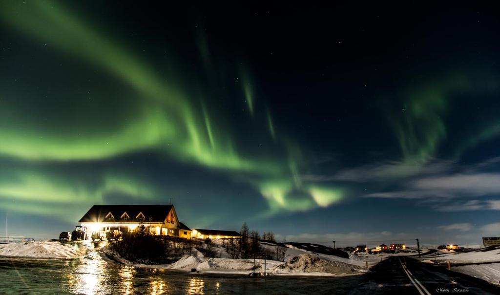 a house with the aurora in the sky at Skútustadir Guesthouse in Myvatn