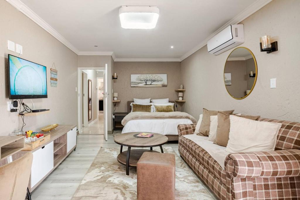 a living room with a couch and a bed at Executive en-Suite, cozy, comfy and spacious in Baragwanath