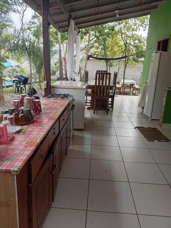 a kitchen with a counter top and a patio at Casa Alter do Chão Com piscina in Santarém
