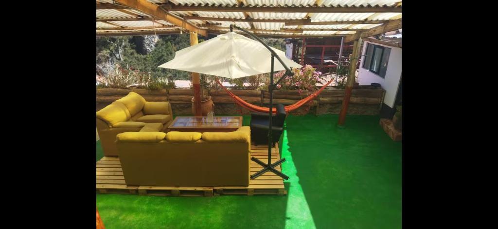 a living room with a couch and an umbrella at Casa Qenqo in Cusco