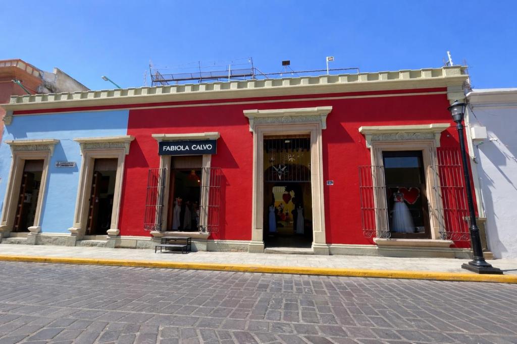 a red building on the side of a street at Atelier Oaxaca in Oaxaca City