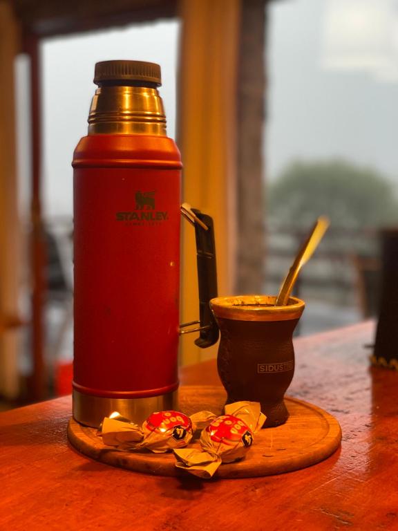 a bottle of sauce and a cup on a table at Huellas de Berna in Villa Berna