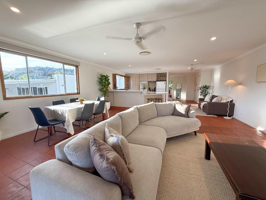 a living room with a couch and a table at The Balcony at Airlie in Airlie Beach