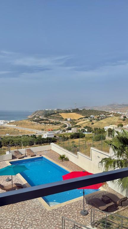 a swimming pool with a view of the ocean at zahara appartement in Tangier