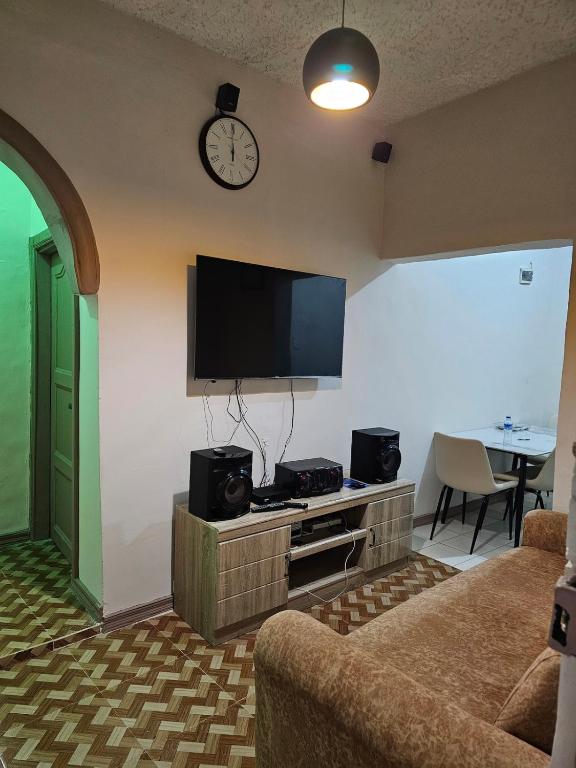 a living room with a flat screen tv on a wall at A nice one bedroom apartment in Mills Center