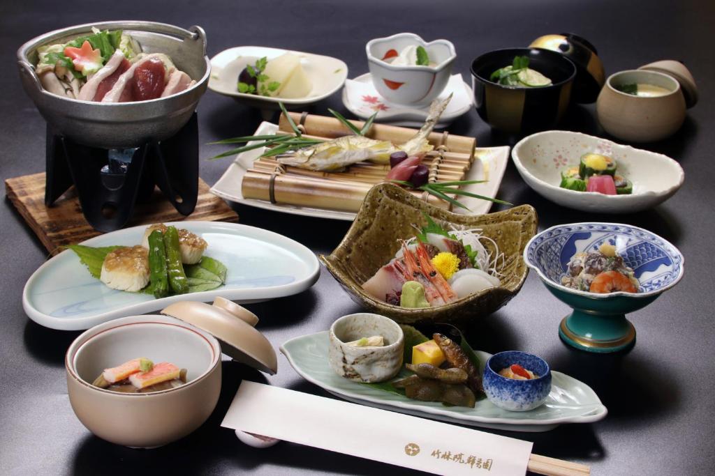 a table topped with plates and bowls of food at Chikurinin Gunpoen in Yoshino