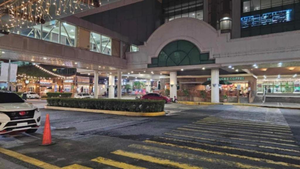 an empty parking lot in a shopping center at night at Monte Carlo Lounge Two in Manila
