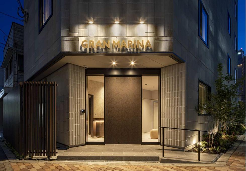 a entrance to a building with a brown door at グランマリーナホテル in Osaka