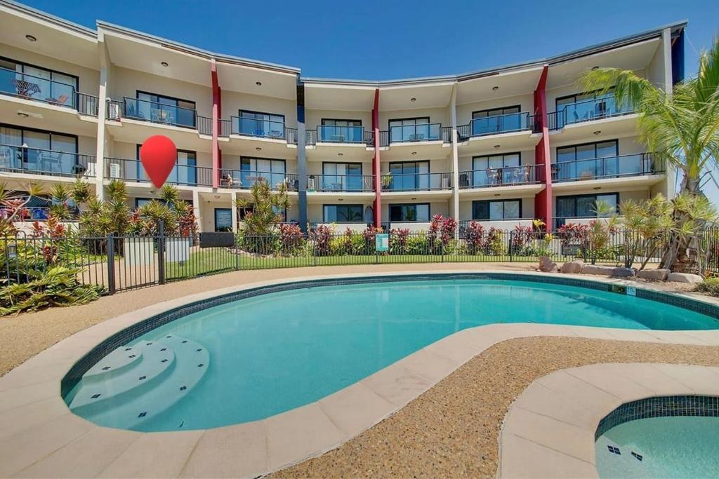 a large apartment building with a large swimming pool at Sea Air 6 in Yeppoon