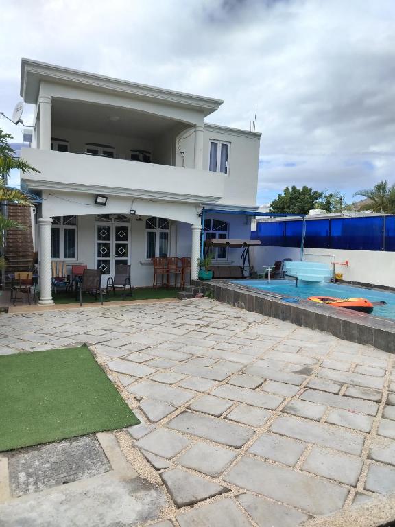 a house with a patio and a swimming pool at Blue Horizon Villa in Grand Baie in Grand-Baie
