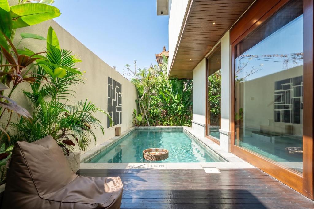 a swimming pool in the backyard of a house at Nala Villa - Peaceful Hideaway with Pool & Yoga Space in Canggu