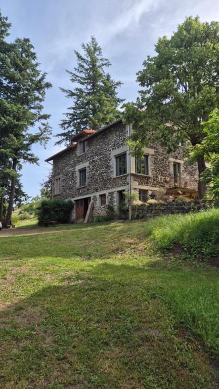 an old stone house in a field with trees at Gite NAYA in Saint-Christophe-sur-Dolaison