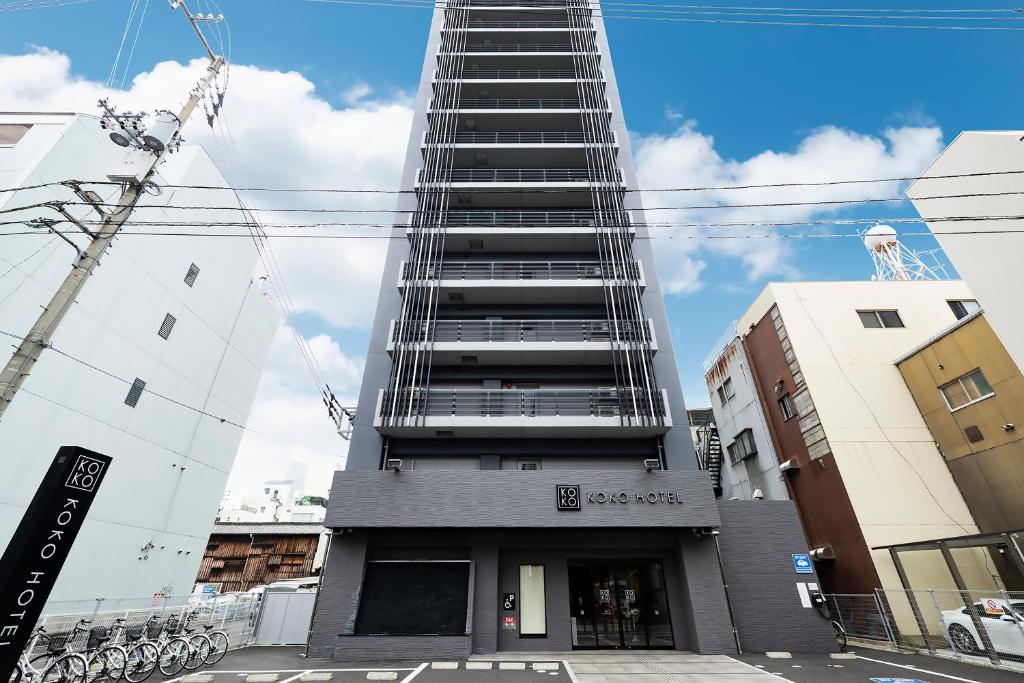 a tall building with stairs on the side of it at KOKO HOTEL Takamatsu in Takamatsu