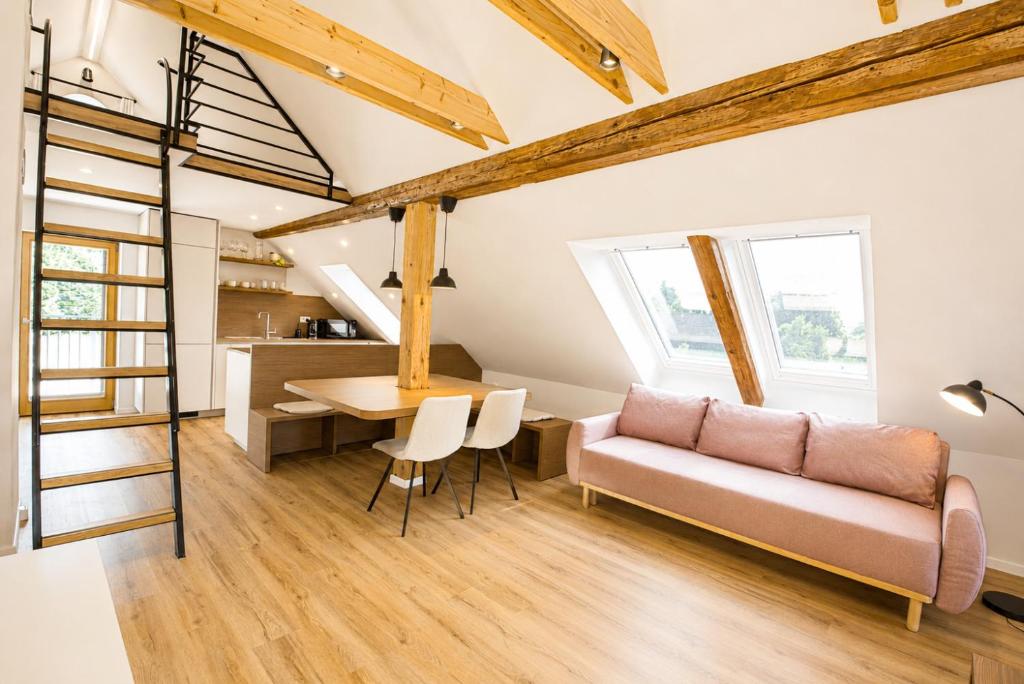 a living room with a couch and a table at Dovce Apartments in Rakek