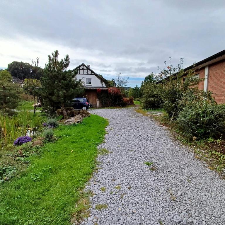 a gravel road in front of a house at Mammut Cottage in Balve