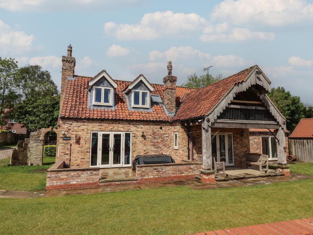 an old brick house with a roof at Redwoods in Beverley