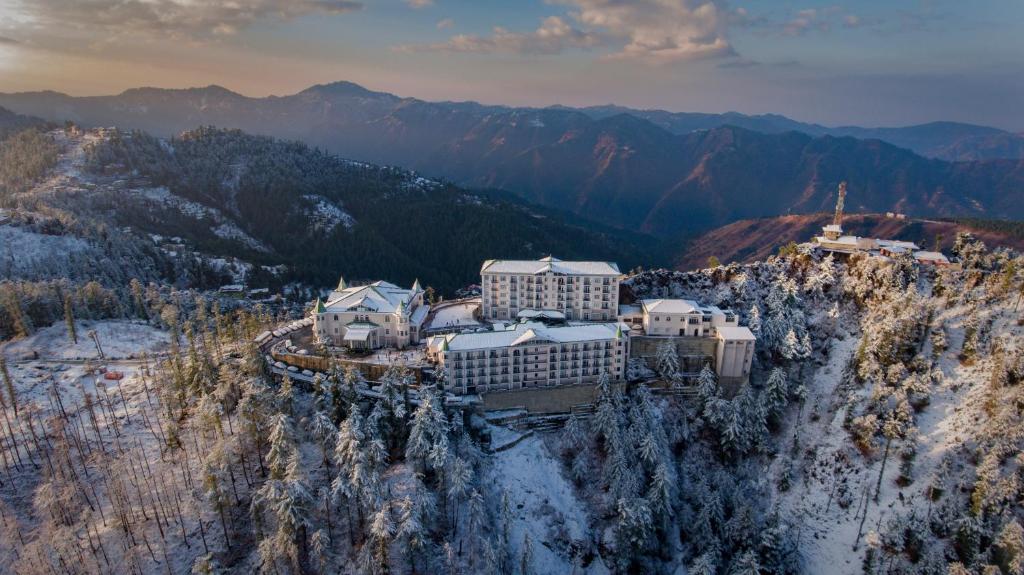 an aerial view of a hotel on a mountain in the snow at Club Mahindra Pristine Peaks Naldehra in Shimla