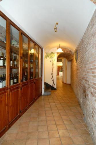 a hallway of a building with a room filled with bottles of wine at Albergo La Conca Azzurra in Conca dei Marini