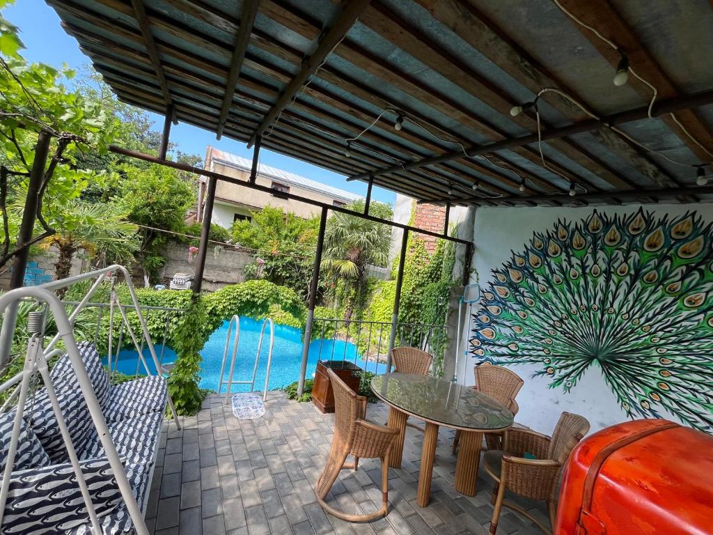 a patio with a table and chairs and a pool at Mtskheta Oasis Garden in Mtskheta