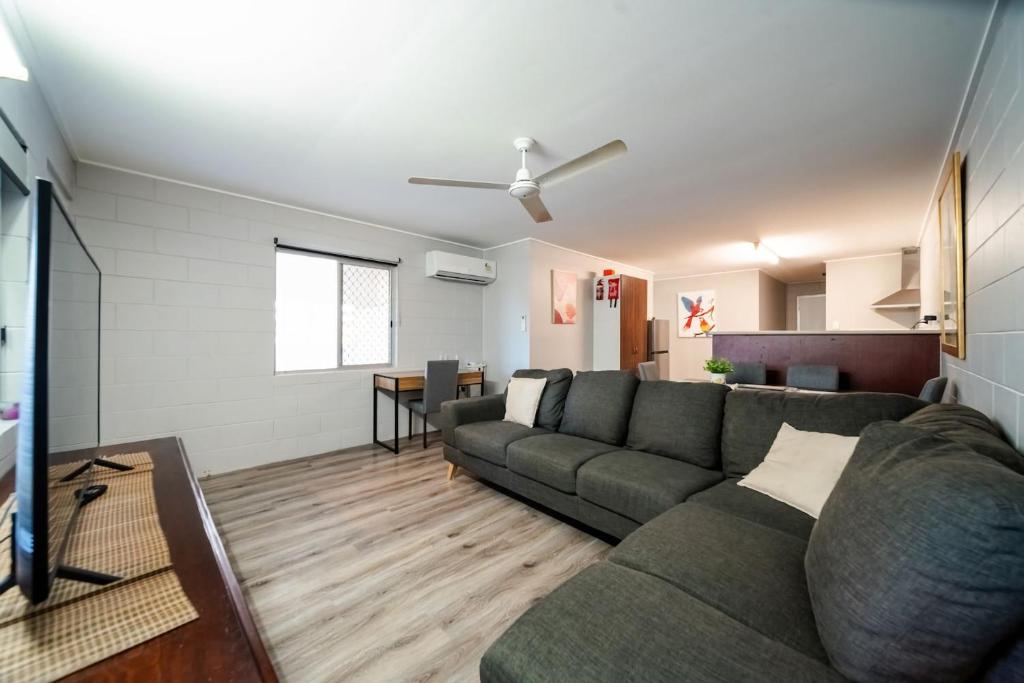 a living room with a couch and a table at Comfy Kirwan Getaway in Ross River