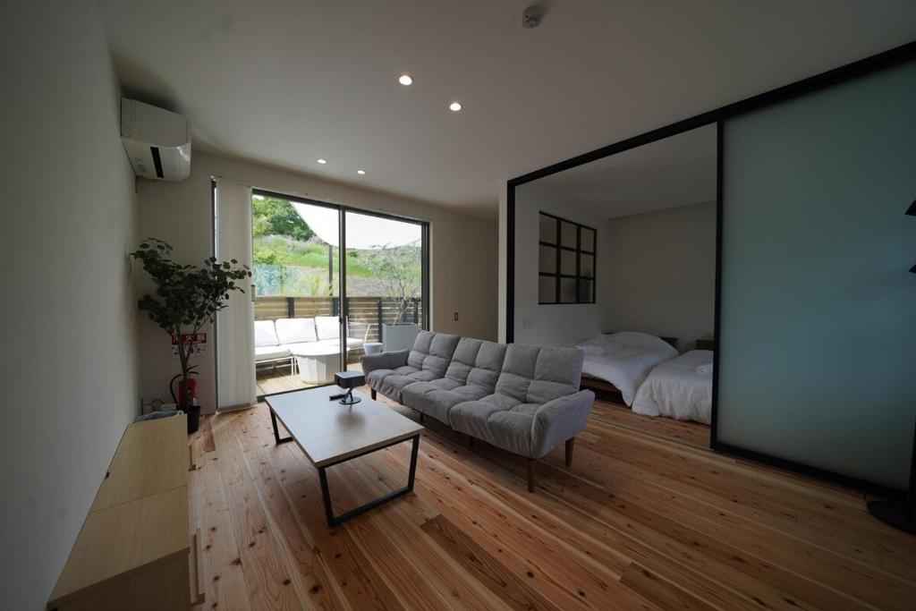 a living room with a couch and a bed at 紀の川みんと間 in Kinokawa