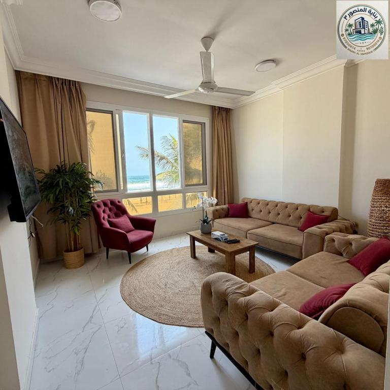 a living room with a couch and a table at المنصور 3 in Salalah