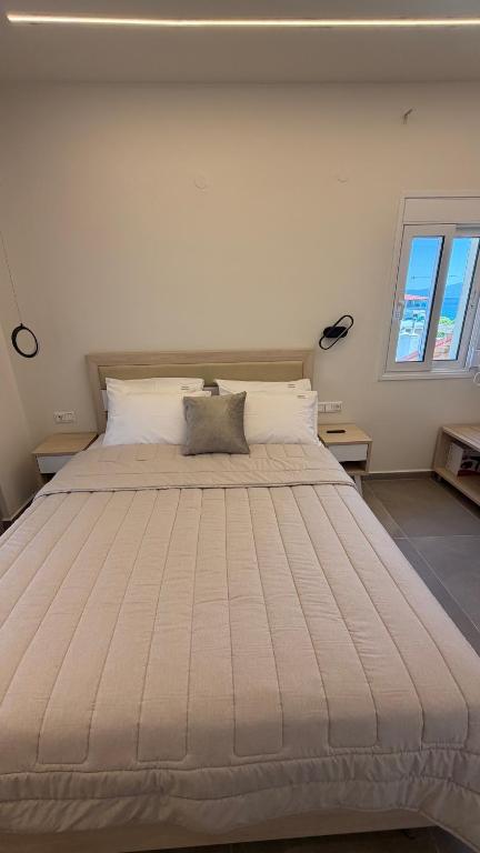 a large bed in a room with two windows at Villa Kostas Sarti in Sarti