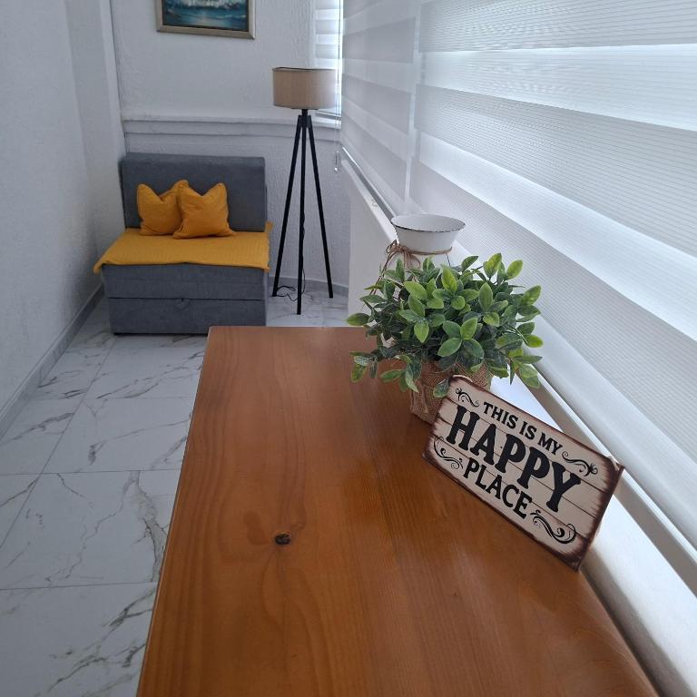 a table with a sign that says this is an happy place at Top Topla - Herceg Novi in Topla