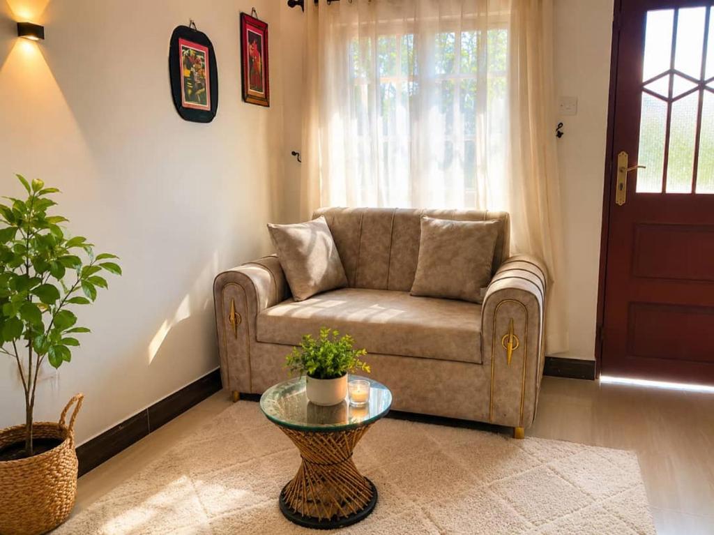 a living room with a couch and a glass table at Kivulini Homes in Arusha