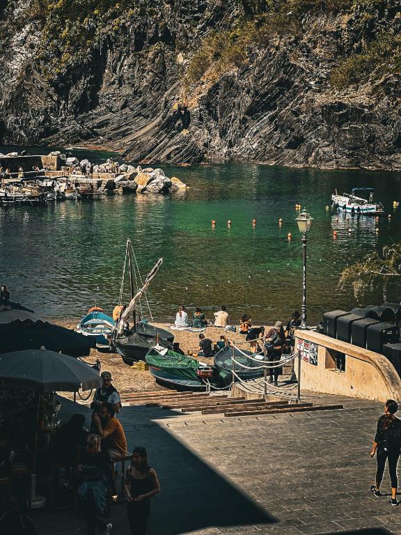 a group of people on a dock in a body of water at VERNAZZA CENTRALE in Vernazza