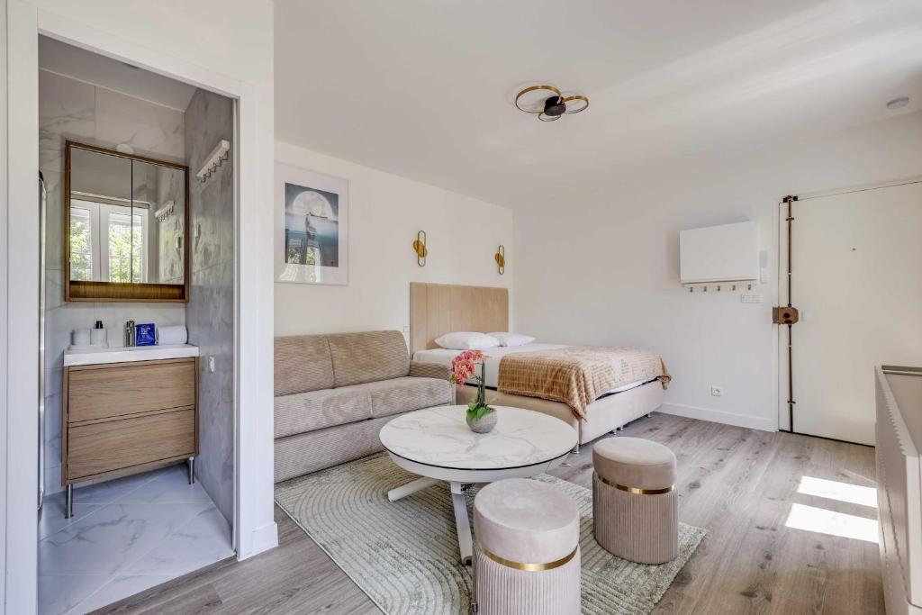 a living room with a couch and a table at Cozy Studio 4P - Aubervilliers in Aubervilliers