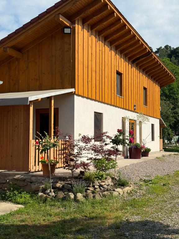 a large wooden building with plants in front of it at Rezi Pava in Pava