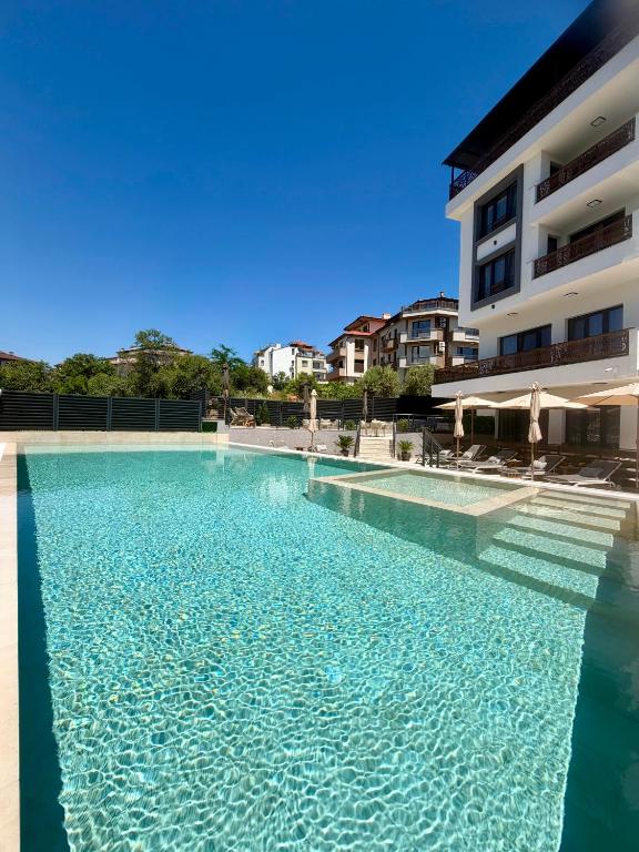 a large swimming pool in front of a building at Limani Vasiliko in Tsarevo