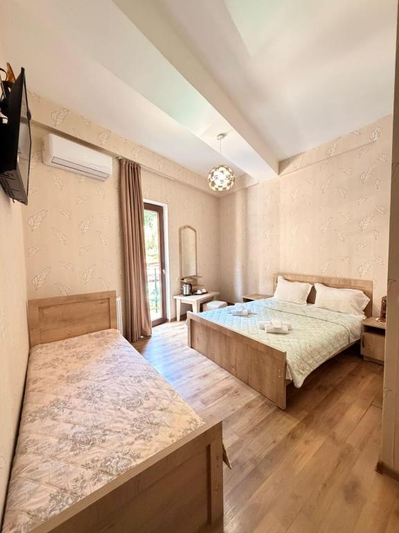 a bedroom with two beds in a room at Hotel Traveler in Kutaisi