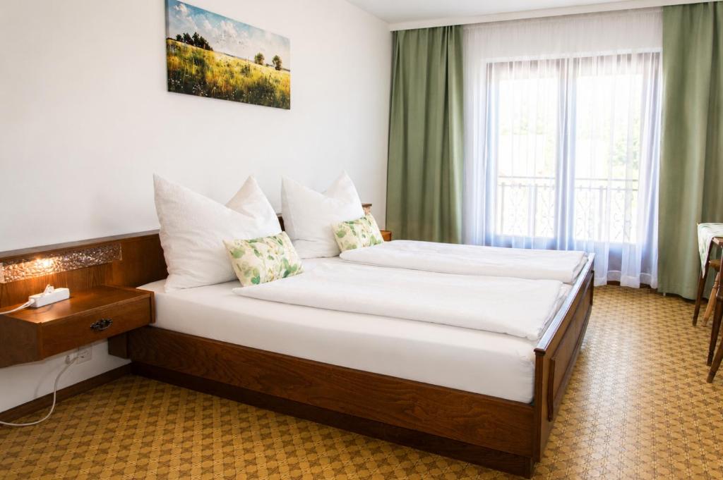 a hotel room with two beds and a window at Gasthaus Zum Stampf in Strass im Attergau