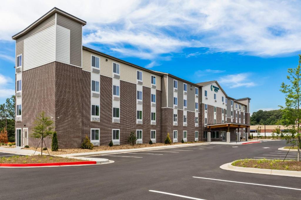 an exterior view of a building with a parking lot at WoodSpring Suites Atlanta Canton in Canton