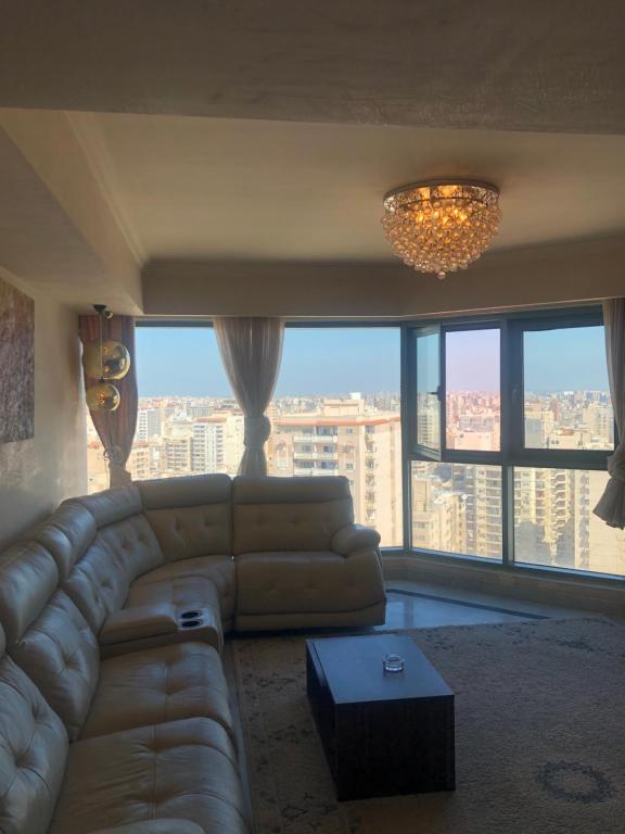 a living room with a couch and a large window at In the clouds in Alexandria